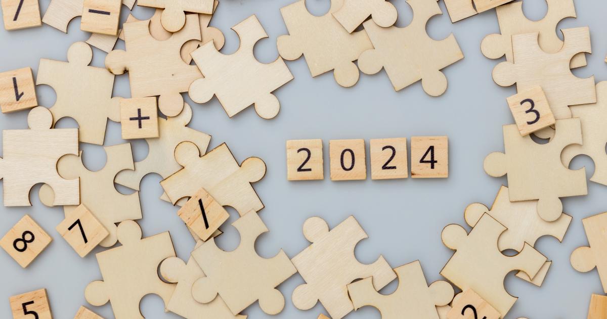 Puzzle pieces and tiles spelling out the year 2024