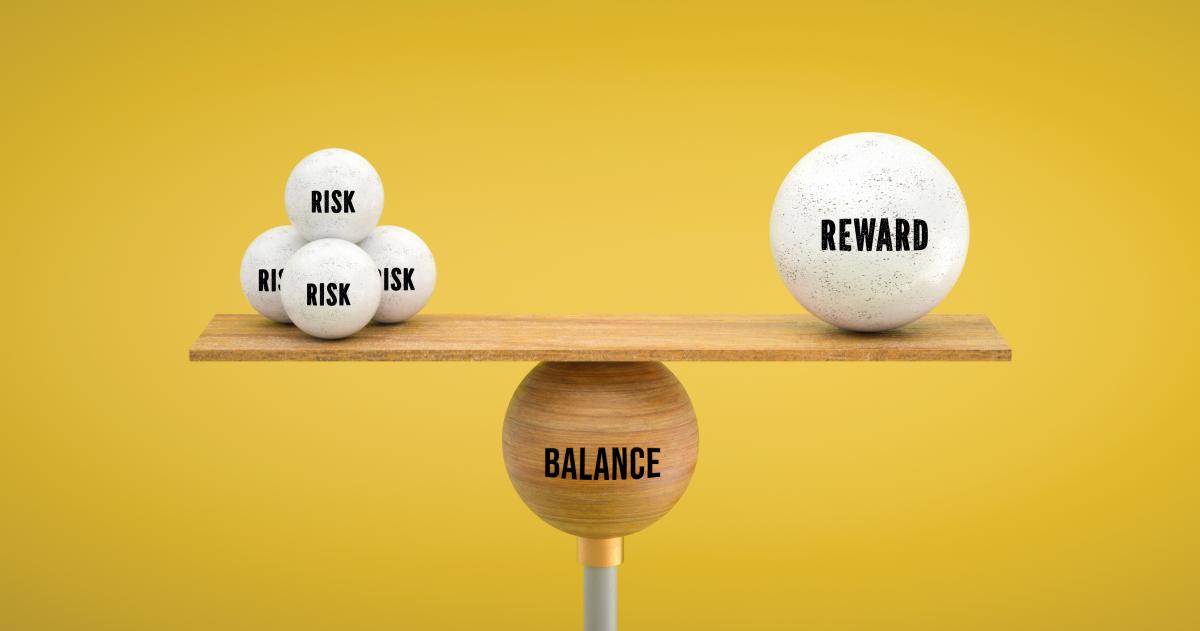 Image with a yellow background with a multiple round objects listed as risk on one side and one round object on the other labeled reward
