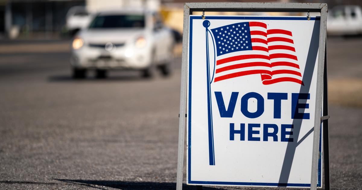 Street sign stating Vote Here