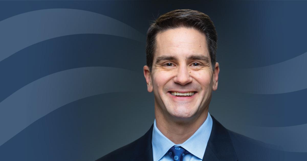 Headshot of Tom Fanter over a blue Curi RMB capital themed bacground