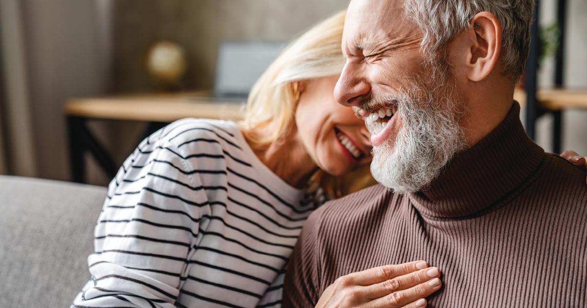 An older couple laughing together