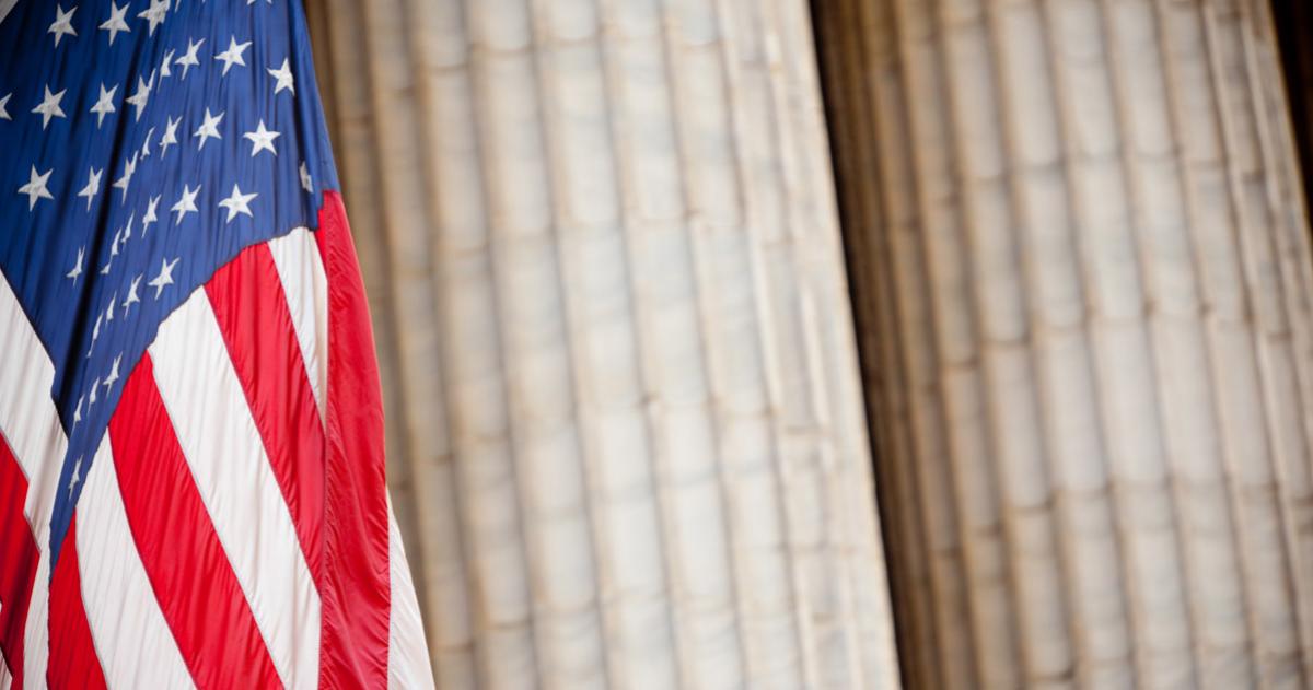 American flag in front of marble column