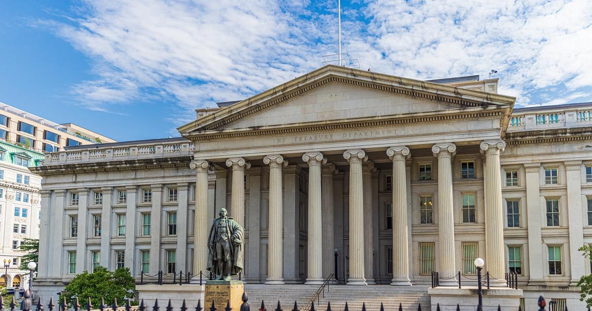 Building with United States flag at the top and a statue in front