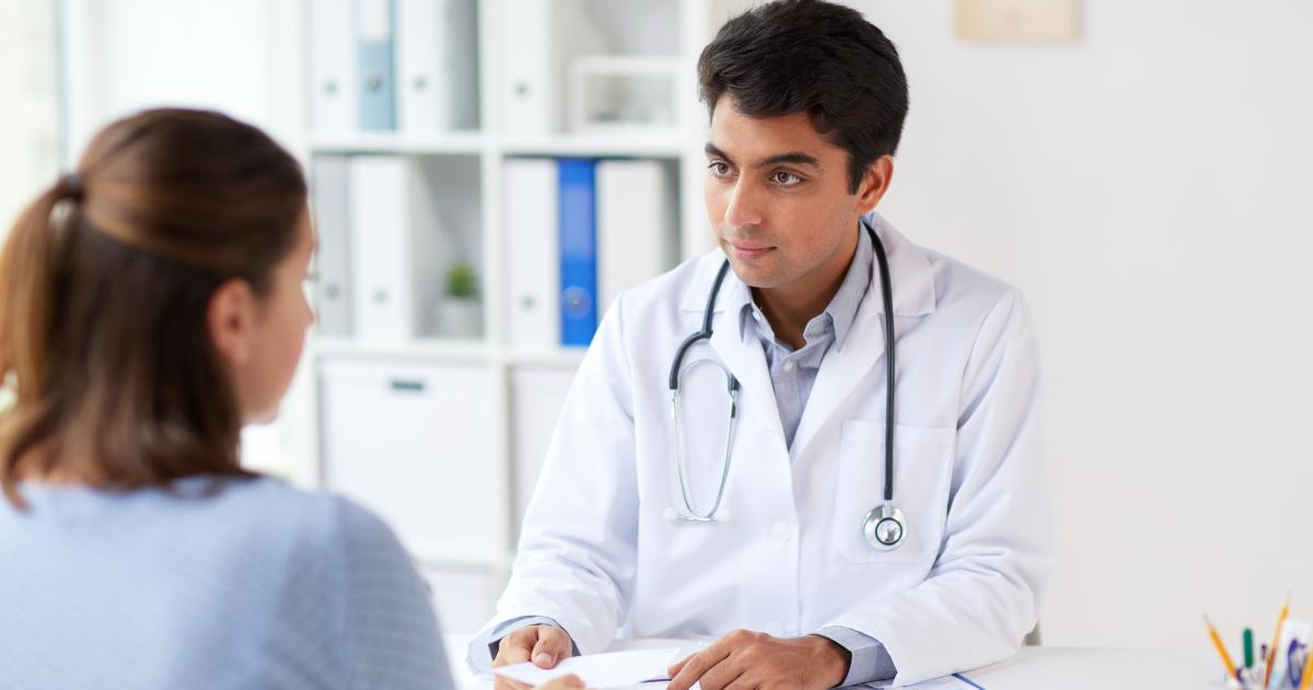 Young physician listening to a patient