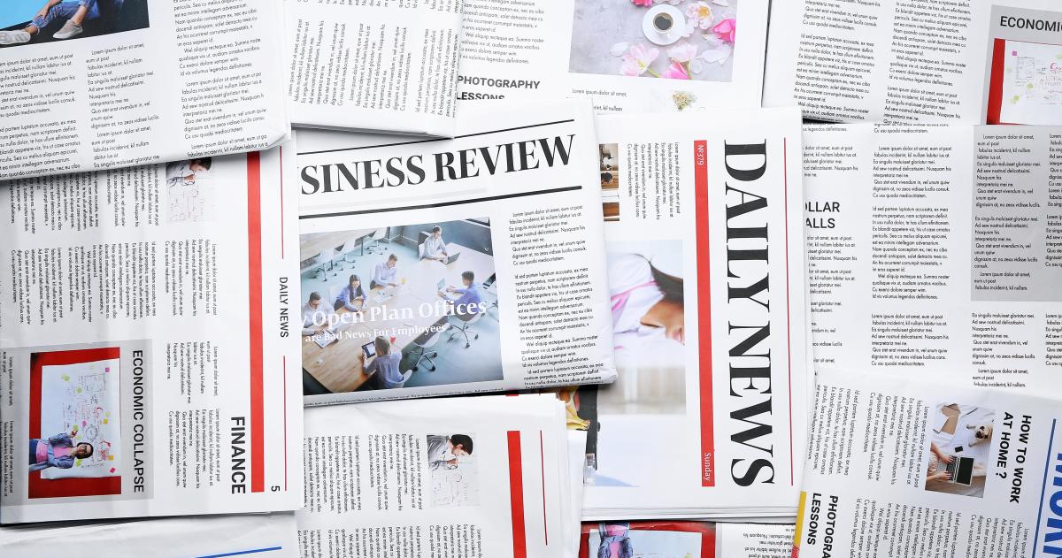 Newspapers spread across table