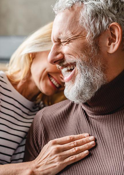 Older couple laughing next to each other